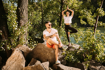 Image showing Young couple having fun and spending time at riverside in sunny day