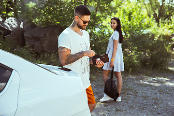 Image showing Young couple preparing for vacation in sunny day