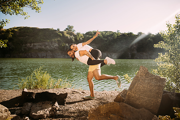 Image showing Young couple having fun and spending time at riverside in sunny day