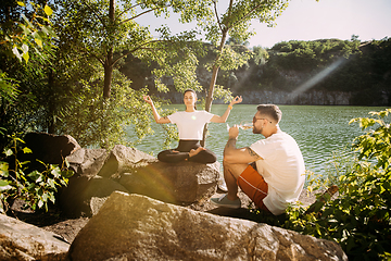 Image showing Young couple having fun and spending time at riverside in sunny day