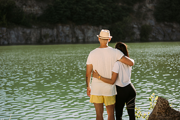 Image showing Young couple having fun and spending time at riverside in sunny day