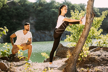 Image showing Young couple having fun and spending time at riverside in sunny day