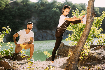 Image showing Young couple having fun and spending time at riverside in sunny day