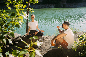 Image showing Young couple having fun and spending time at riverside in sunny day