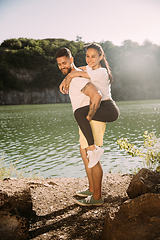 Image showing Young couple having fun and spending time at riverside in sunny day