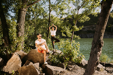 Image showing Young couple having fun and spending time at riverside in sunny day