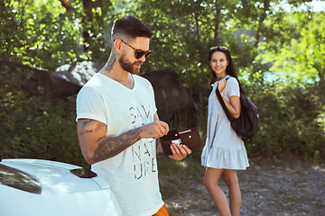 Image showing Young couple preparing for vacation in sunny day