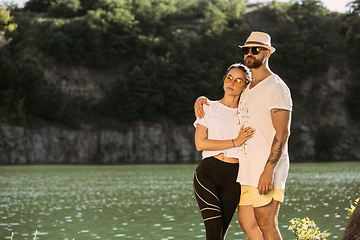 Image showing Young couple having fun and spending time at riverside in sunny day