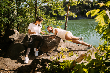 Image showing Young couple having fun and spending time at riverside in sunny day