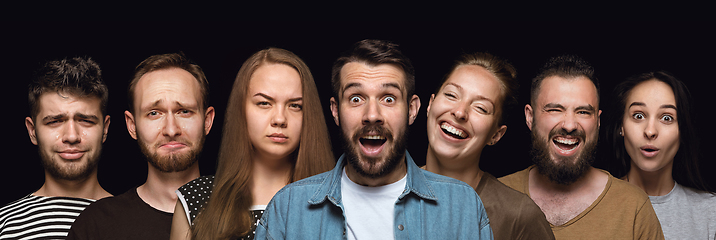 Image showing Close up portrait of young people isolated on black studio background