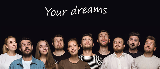 Image showing Close up portrait of young people isolated on black studio background