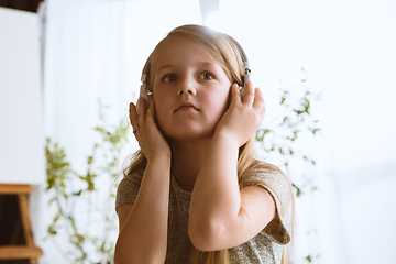 Image showing Little girl using different gadgets at home