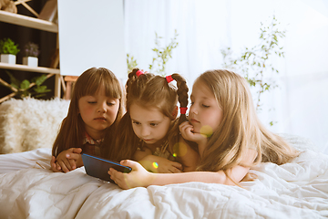 Image showing Little girls using different gadgets at home