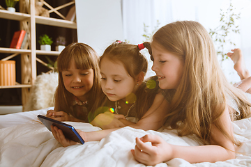 Image showing Little girls using different gadgets at home