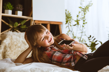 Image showing Little girl using different gadgets at home