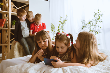 Image showing Little boys and girls using different gadgets at home
