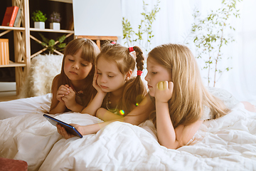 Image showing Little girls using different gadgets at home