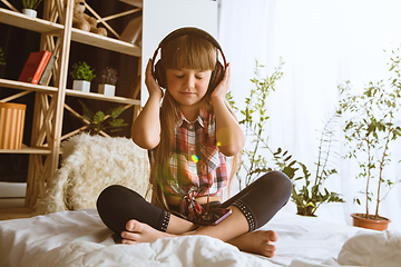 Image showing Little girl using different gadgets at home