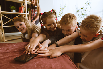 Image showing Little boys and girls using different gadgets at home