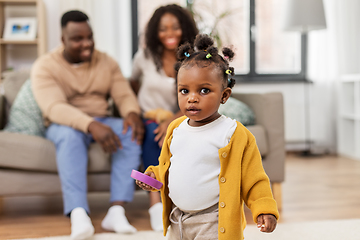 Image showing african baby girl playing with toy blocks at home