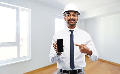 Image showing indian male architect in helmet showing smartphone