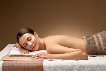 Image showing young woman lying at spa or massage parlor