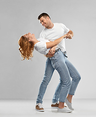 Image showing portrait of happy couple in white t-shirts dancing