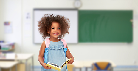 Image showing happy little african girl with book and backpack