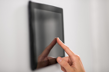 Image showing hand using tablet computer at smart home