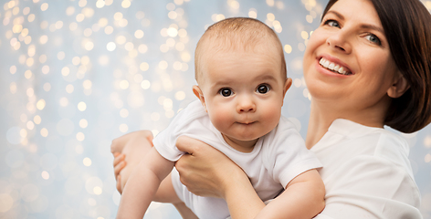 Image showing happy middle-aged mother with little baby daughter