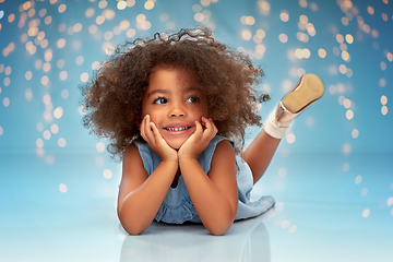 Image showing happy little african american girl lying on floor