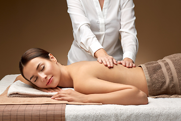 Image showing woman lying and having back massage at spa