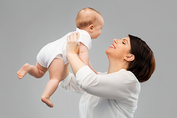 Image showing happy middle-aged mother with little baby daughter