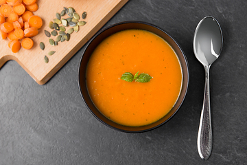 Image showing vegetable pumpkin cream soup in bowl with spoon