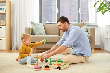 Image showing father playing with little baby daughter at home