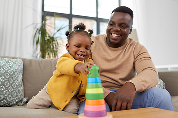 Image showing african family playing with baby daughter at home