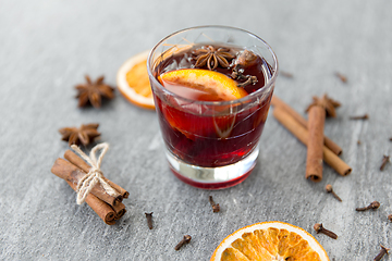 Image showing hot mulled wine, orange slices, raisins and spices