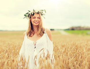 Image showing happy young woman in flower wreath on cereal field