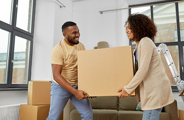 Image showing happy couple with boxes moving to new home