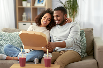 Image showing happy african american couple eating pizza at home