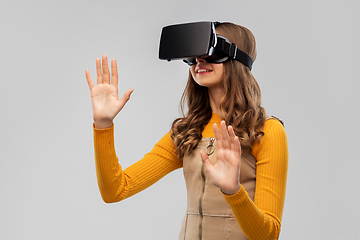 Image showing teenage girl in vr glasses over grey background