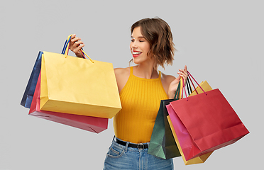 Image showing happy smiling young woman with shopping bags