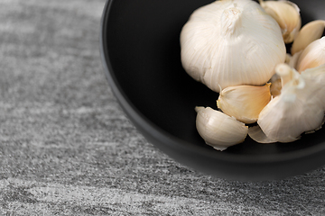 Image showing garlic in bowl on slate stone background