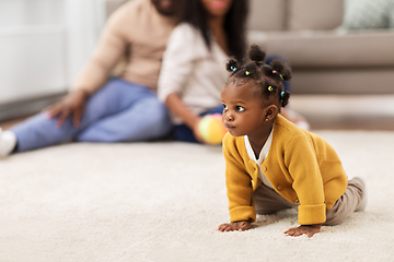 Image showing african american baby crawling on floor at home