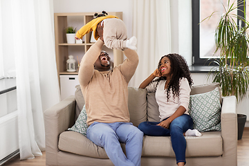 Image showing african family playing with baby daughter at home