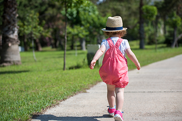 Image showing little girl runing in the summer Park