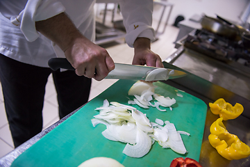 Image showing Chef hands cutting fresh and delicious vegetables