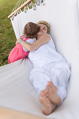 Image showing mother and a little daughter relaxing in a hammock