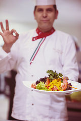 Image showing Chef showing a plate of tasty meal