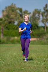 Image showing young female runner training for marathon